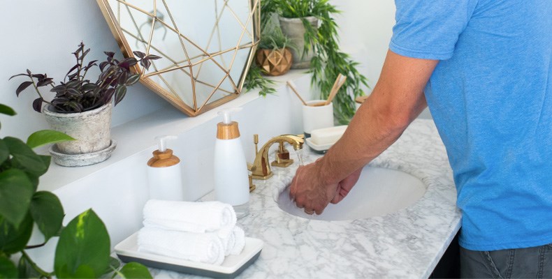 Man washing hands in bathroom